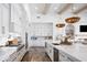 Spacious white kitchen with stainless steel appliances, a large island, and hardwood floors at 19901 E Country Meadows Dr, Queen Creek, AZ 85142