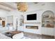 Cozy living room featuring a modern fireplace, built-in shelving, and stylish decor at 19901 E Country Meadows Dr, Queen Creek, AZ 85142
