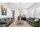 Elegant living room with plush sofas, modern lighting, and stylish decor for comfortable living at 19901 E Country Meadows Dr, Queen Creek, AZ 85142