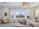Tranquil bedroom with large windows offering backyard views and a cozy seating area at 19901 E Country Meadows Dr, Queen Creek, AZ 85142