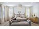 Serene main bedroom with neutral tones, stylish furniture, and natural light at 19901 E Country Meadows Dr, Queen Creek, AZ 85142