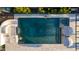 Aerial view of a backyard pool with a slide, waterfall feature, and tiled deck at 19901 E Country Meadows Dr, Queen Creek, AZ 85142