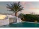 Beautiful waterfall feature flowing into the pool surrounded by lush landscaping at 19901 E Country Meadows Dr, Queen Creek, AZ 85142