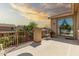 Balcony with a wrought iron railing, a small table, and sunset views at 21557 N Anne Ln, Maricopa, AZ 85138