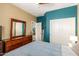Bright bedroom features stylish furnishings, natural light from the window, and access to a spacious closet at 21557 N Anne Ln, Maricopa, AZ 85138