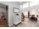 Elegant home foyer featuring soaring ceilings, natural light, and a graceful staircase leading to the upper level at 21557 N Anne Ln, Maricopa, AZ 85138