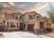 Attractive two-story home with desert landscaping, a cozy porch, and a convenient two-car garage at 21557 N Anne Ln, Maricopa, AZ 85138