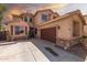 Inviting residence featuring a two-car garage, and desert landscaping, nestled in a welcoming neighborhood at 21557 N Anne Ln, Maricopa, AZ 85138