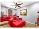 Cozy home theater room featuring plush seating, a ceiling fan, and a vibrant painting for a relaxing atmosphere at 21557 N Anne Ln, Maricopa, AZ 85138