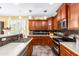 Well-lit kitchen features stainless steel appliances, granite countertops, tile backsplash, and eat-in bar at 21557 N Anne Ln, Maricopa, AZ 85138