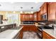 Well-lit kitchen features stainless steel appliances, granite countertops, tile backsplash, and eat-in bar at 21557 N Anne Ln, Maricopa, AZ 85138