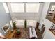 Bright, high ceiling living room with tile floor, comfortable seating, and large windows with natural light at 21557 N Anne Ln, Maricopa, AZ 85138