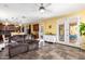 Open floor plan shows a living area with comfortable seating and doors to a bright backyard at 21557 N Anne Ln, Maricopa, AZ 85138