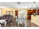 Bright living room and dining area featuring an open layout with modern decor and fixtures at 21557 N Anne Ln, Maricopa, AZ 85138