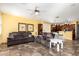 The open layout features a living room with comfortable seating leading into a bright kitchen at 21557 N Anne Ln, Maricopa, AZ 85138