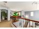 Large loft area with stairway, neutral carpet, potted tree, and plenty of natural light at 21557 N Anne Ln, Maricopa, AZ 85138
