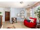 Open loft sitting area featuring blue walls, stylish furniture, carpet floors and plenty of natural light at 21557 N Anne Ln, Maricopa, AZ 85138