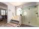 Main bathroom features a soaking tub, a glass-enclosed shower, and light tile flooring at 21557 N Anne Ln, Maricopa, AZ 85138