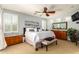 Spacious main bedroom boasts a ceiling fan, shutters, and well-coordinated furniture set at 21557 N Anne Ln, Maricopa, AZ 85138
