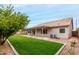A spacious backyard with lush green grass and a covered patio area, ideal for outdoor living at 2319 E San Tan Dr, Gilbert, AZ 85296