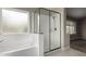 Bathroom featuring a soaking tub, glass-enclosed shower, and a bright window at 2319 E San Tan Dr, Gilbert, AZ 85296