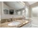 Close-up of bathroom with dual sinks, granite countertops, and decorative lighting at 2319 E San Tan Dr, Gilbert, AZ 85296