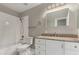 Bathroom featuring a shower-tub combo and vanity with granite countertop at 2319 E San Tan Dr, Gilbert, AZ 85296