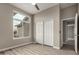 Bright bedroom featuring wood-look floors, a closet with sliding doors, and large window at 2319 E San Tan Dr, Gilbert, AZ 85296