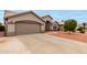 Welcoming single-story home with a two-car garage and a desert-landscaped front yard at 2319 E San Tan Dr, Gilbert, AZ 85296