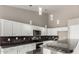 Modern kitchen featuring white cabinets, granite countertops, and stainless steel appliances at 2319 E San Tan Dr, Gilbert, AZ 85296