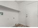 Simple white laundry room with utility hook-ups and a shelf at 2319 E San Tan Dr, Gilbert, AZ 85296