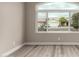 Bright living room with plank flooring and a large window offering a neighborhood view at 2319 E San Tan Dr, Gilbert, AZ 85296