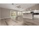 Open concept living space with updated flooring flowing into the adjacent kitchen and dining area at 2319 E San Tan Dr, Gilbert, AZ 85296