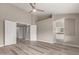 Spacious main bedroom with ensuite bathroom, double doors, and wood-look flooring at 2319 E San Tan Dr, Gilbert, AZ 85296