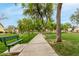 Scenic park view with walking path, green bench, mature trees, and a lush green lawn at 2319 E San Tan Dr, Gilbert, AZ 85296