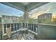 Private balcony features a small metal table and two chairs with neighborhood views at 2402 E 5Th St # 1532, Tempe, AZ 85288