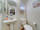 Stylish half-bath featuring a pedestal sink, modern fixtures, and a clean, minimalist design at 2402 E 5Th St # 1532, Tempe, AZ 85288