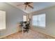 Bedroom with neutral carpet, ceiling fan, and a dedicated workspace with two monitors at 2402 E 5Th St # 1532, Tempe, AZ 85288