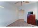Bedroom featuring plush carpet, and a wooden dresser with a mounted television on top at 2402 E 5Th St # 1532, Tempe, AZ 85288