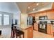 Kitchen with wooden cabinets, island, and tile floors at 2402 E 5Th St # 1532, Tempe, AZ 85288