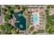 Aerial view of a community with a pool, pond, and green spaces at 2658 S Sulley Dr # 102, Gilbert, AZ 85295