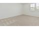 A light and bright bedroom features neutral carpet and two windows at 2658 S Sulley Dr # 102, Gilbert, AZ 85295