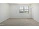 A cozy bedroom includes neutral carpet, natural light, and a door at 2658 S Sulley Dr # 102, Gilbert, AZ 85295