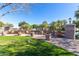 Inviting community green space accented with large planters filled with flowers and shade trees overlooking a serene lake at 2658 S Sulley Dr # 102, Gilbert, AZ 85295