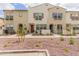 Attractive townhome facade with colorful accents, desert landscaping, and welcoming front patios at 2658 S Sulley Dr # 102, Gilbert, AZ 85295