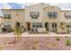 Exterior view of well-maintained townhomes with desert landscaping and charming architectural details at 2658 S Sulley Dr # 102, Gilbert, AZ 85295