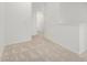 A hallway with neutral carpeting leads to an open doorway at 2658 S Sulley Dr # 102, Gilbert, AZ 85295