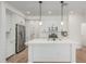 Modern kitchen with white cabinets, stainless steel appliances, and a large center island with sink at 2658 S Sulley Dr # 102, Gilbert, AZ 85295