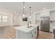 Spacious open-concept layout with kitchen island, flowing seamlessly into the living area with abundant natural light at 2658 S Sulley Dr # 102, Gilbert, AZ 85295