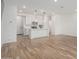 Open-concept living space with wood floors connecting to a modern kitchen with an island and stainless steel appliances at 2658 S Sulley Dr # 102, Gilbert, AZ 85295